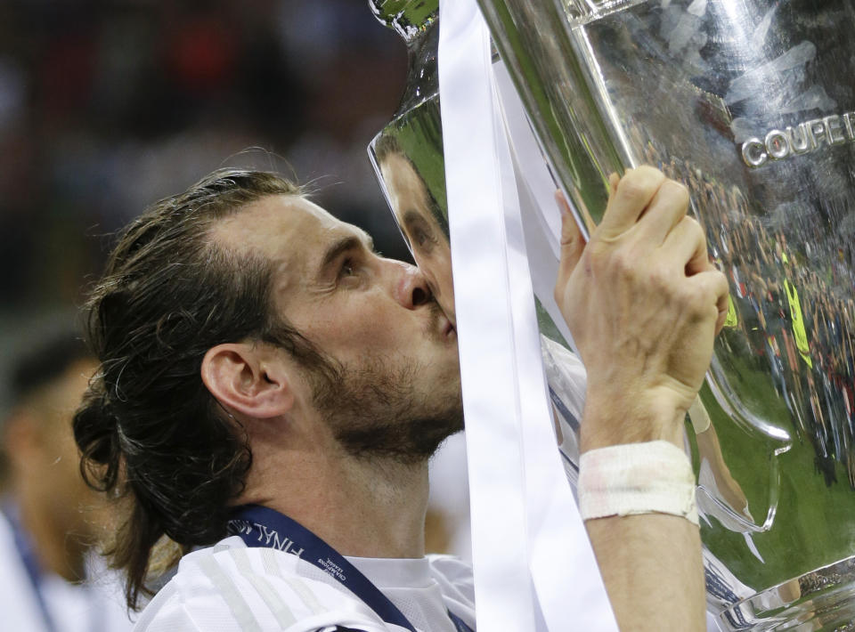 FILE - Real Madrid's Gareth Bale kisses the trophy after the Champions League final soccer match between Real Madrid and Atletico Madrid at the San Siro stadium in Milan, Italy, Saturday, May 28, 2016. (AP Photo/Andrew Medichini, File)