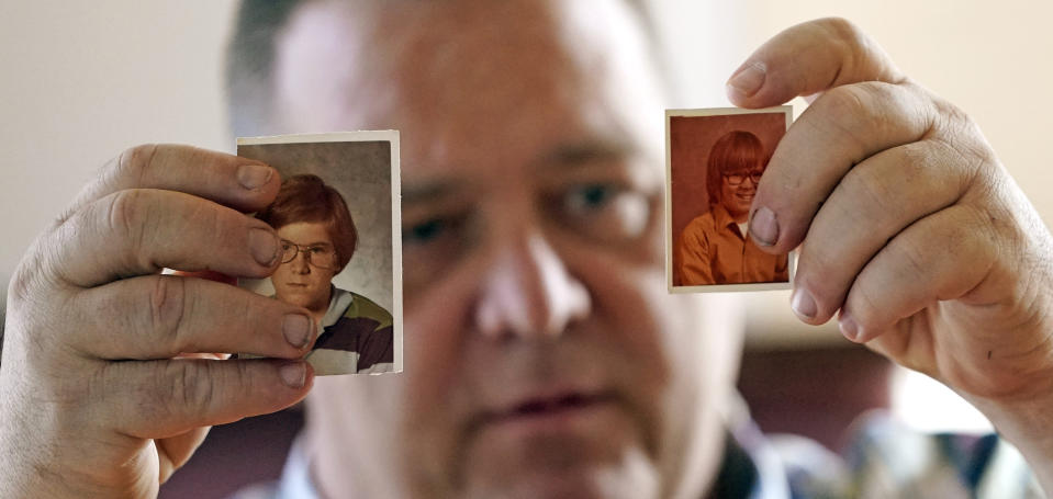 In this Thursday, Feb. 13, 2020, photo, James Kretschmer holds photographs of himself at age 11 and 12 during an interview in Houston. The Boy Scouts of America has filed for bankruptcy protection as it faces a barrage of new sex-abuse lawsuits. The filing Tuesday, Feb. 18, in Wilmington, Del., is an attempt to work out a potentially mammoth compensation plan for abuse victims that will allow the 110-year-old organization to carry on. Kretschmer of Houston, among the many men suing for alleged abuse, says he was molested by a Scout leader over several months in the mid-1970s in the Spokane, Washington, area. (AP Photo/David J. Phillip)