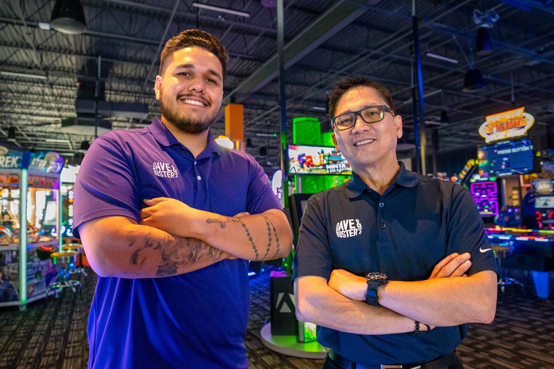 Dave & Buster’s Area Operations Manager Angel Contreras, left, and General Manager John Aguilar, right, stand in front of the gaming area inside of Dave & Busters in Folsom on Tuesday, March 26, 2024. Cameron Clark/cclark@sacbee.com