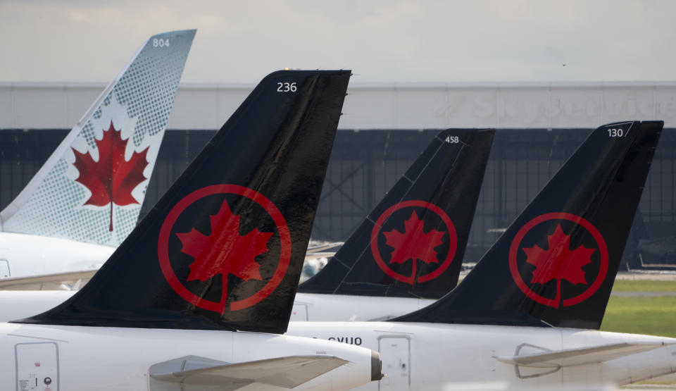 Air Canada logos are seen on the tails of planes at the airport in Montreal on Monday, June 26, 2023. Air Canada reported a profit of $1.25 billion in its latest quarter compared with a loss of $508 million in the same quarter last year. THE CANADIAN PRESS/Adrian Wyld