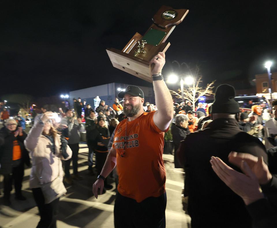 Massillon Tigers head coach Nate Moore leads his team into Duncan Plaza in Massillon for a celebratory rally after winning the OHSAA Division II state title Thursday in Canton.