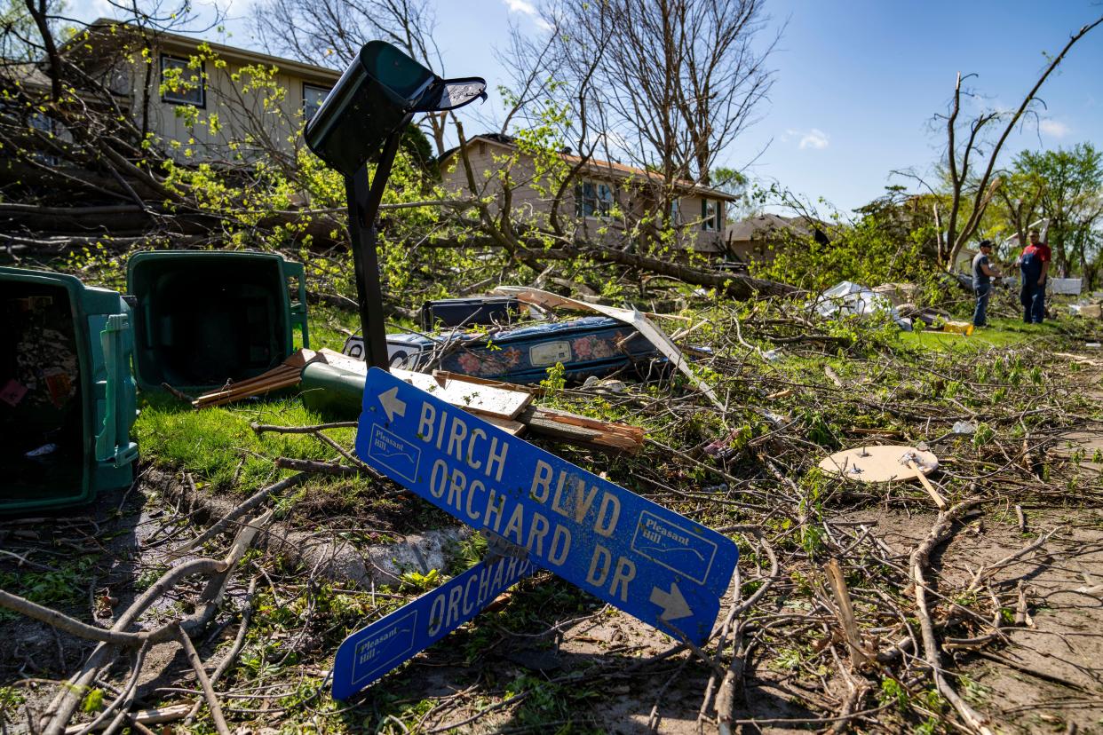 Residents clean up debris in Pleasant Hill, Iowa, on Saturday, April 27, 2024, after multiple tornadoes ripped across the state Friday evening.