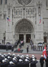 The casket of U.S. Marine Corps Staff Sergeant and FDNY Firefighter Christopher Slutman, center, arrives for his funeral service at St. Thomas Episcopal Church, Friday April 26, 2019, in New York. The father of three died April 8 near Bagram Airfield U.S military base in Afghanistan. (AP Photo/Bebeto Matthews)