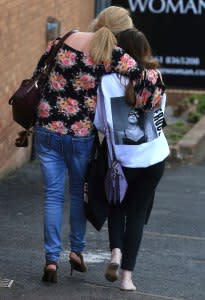 A fan is comforted as she leaves the Park Inn hotel in central Manchester, England, on May 23, 2017.