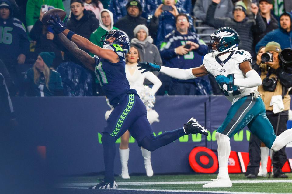 Dec 18, 2023; Seattle, Washington, USA; Seattle Seahawks wide receiver Jaxon Smith-Njigba (11) catches a touchdown pass against Philadelphia Eagles cornerback James Bradberry (24) during the fourth quarter at Lumen Field.