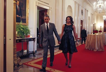 U.S. President Barack Obama and first lady Michelle Obama arrive at the "A Celebration of Special Olympics and A Unified Generation" event at the White House in Washington, July 31, 2014. REUTERS/Yuri Gripas