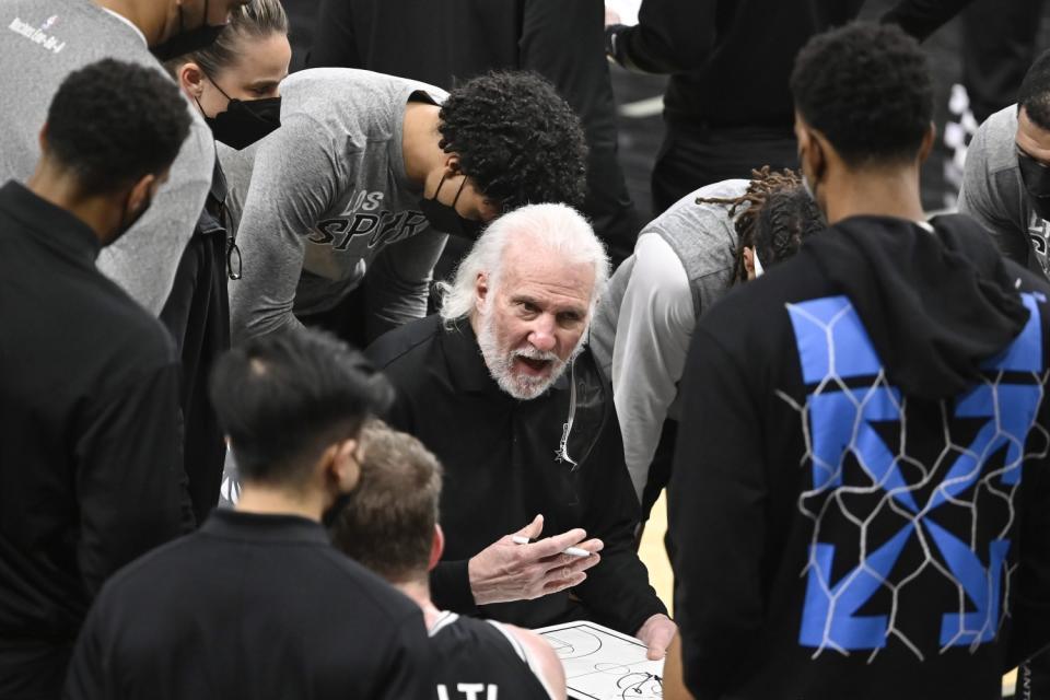 San Antonio Spurs head coach Gregg Popovich talks to his players during a game against the Charlotte Hornets on March 22.