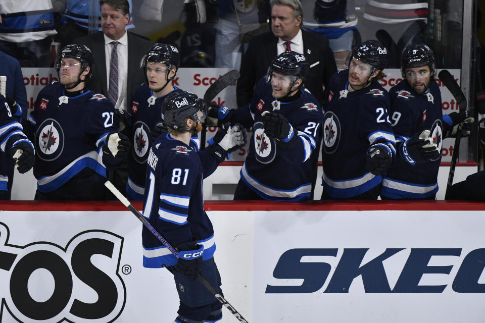 Winnipeg Jets' Kyle Connor (81) celebrates his empty-net goal against the New York Islanders during the third period of an NHL hockey game Tuesday, Jan. 16, 2024, in Winnipeg, Manitoba. (Fred Greenslade/The Canadian Press via AP)