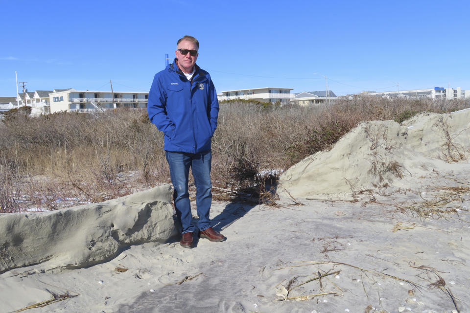 FILE - Mayor Patrick Rosenello stands next to a destroyed section of sand dune in North Wildwood N.J. Jan. 22, 2024. On April 25, 2024, North Wildwood and the state of New Jersey announced an agreement for an emergency beach replenishment project there to protect the city until a full-blown beach fill can be done by the U.S. Army Corps of Engineers that may still be two years away. Winter storms punched a hole through what is left of the city's eroded dune system, leaving it more vulnerable than ever to destructive flooding. (AP Photo/Wayne Parry, File)