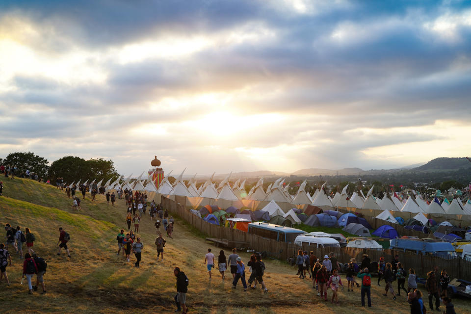 The sun sets over the Worthy Farm festival in June, 2019.