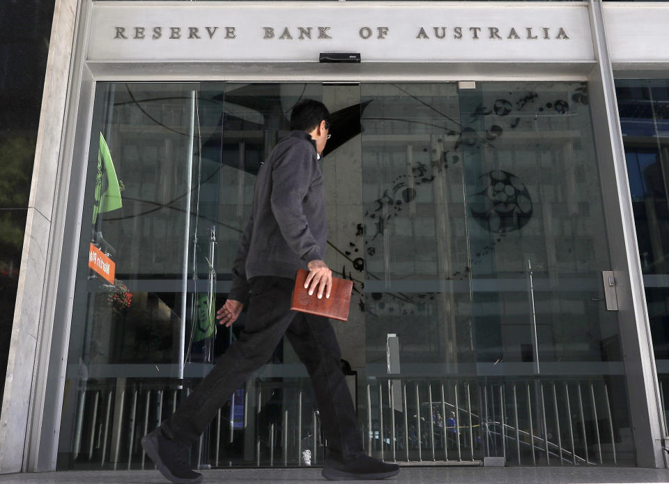 A man walks past the Reserve Bank of Australia in Sydney, Tuesday, Oct. 1, 2019. Australia's central bank cut its benchmark interest rate by a quarter of a percentage point for the third time since June to a new record low of 0.75%, seeking to boost a flagging economy. (AP Photo/Rick Rycroft)