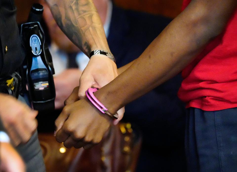 A 14-year-old is handcuffed and escorted out of the courtroom of Hamilton County Juvenile Court Judge Kari L. Bloom. The teen was incarcerated in the Hamilton County Juvenile Youth Center. He made a plea of admitting to two felonies, one of which was an assault on a correctional officer, and one misdemeanor.