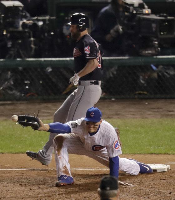 Corey Kluber is safe at first after Kris Bryant's second throwing error in the second inning. (AP)