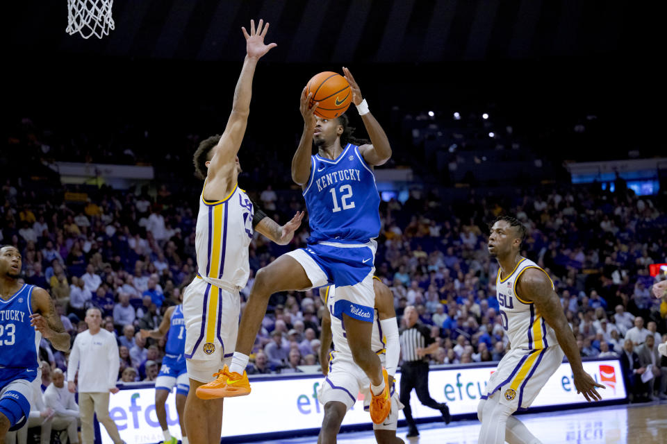 Kentucky guard Antonio Reeves (12) shoots against LSU forward Jalen Reed, front left, during the first half of an NCAA college basketball game in Baton Rouge, La., Wednesday, Feb. 21, 2024. (AP Photo/Matthew Hinton)