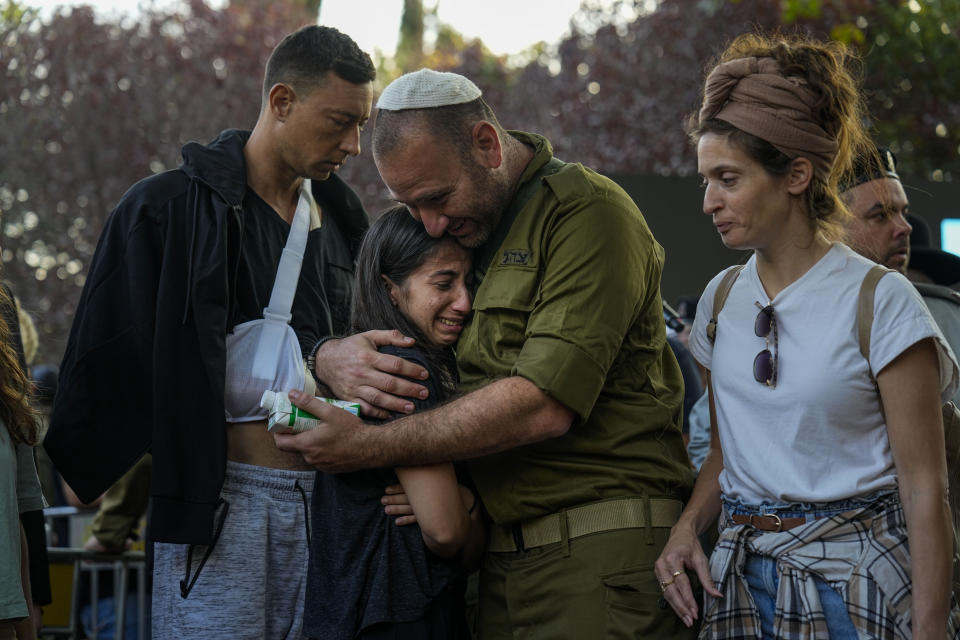 Mourners gather around the grave of Israeli reserve soldier captain Omri Yosef David during his funeral in Carmiel, northern Israel, Wednesday, Nov. 15, 2023. David, 27, was killed during a military ground operation in the Gaza Strip. (AP Photo/Ariel Schalit)