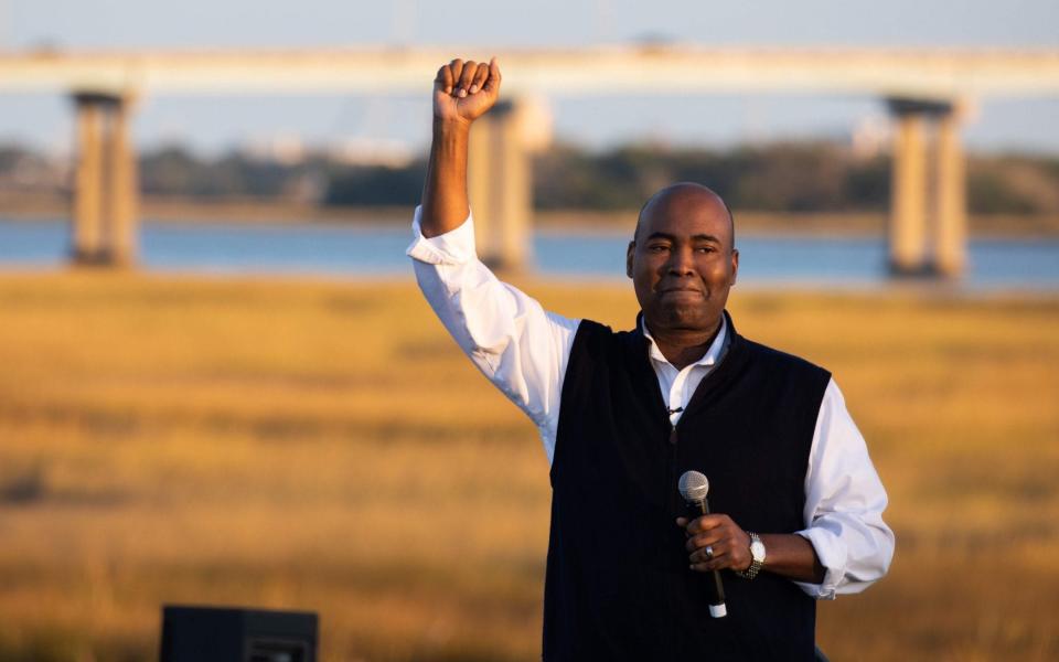 Democratic candidate for Senate Jaime Harrison waves to supporters during a socially distanced drive-in rally held at The Bend in North Charleston - AFP