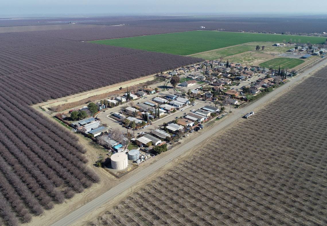The small farming community of Cantua Creek can be seen surrounded by farmland in the Central San Joaquin Valley from a drone camera on Wednesday, Feb. 8, 2023.