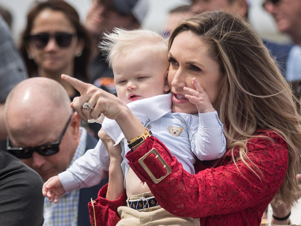 Lara Trump holds son Luke at a Trump gold club event