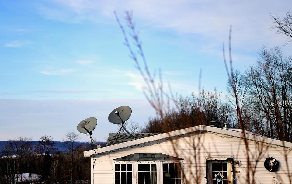 This 2019 file photos shows satellite dishes on rural homes in Steuben County, where families often can't access internet any other way. Satellite internet is often slow, and unable to handle high demand from multiple users in a household.