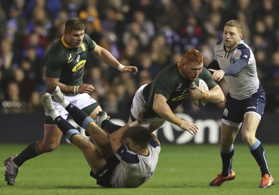 South Africa's Steven Kitshoff, second right, is tackled by Scotland's Huw Jones, bottom, during the rugby union international match between Scotland and South Africa at Murrayfield stadium, in Edinburgh, Scotland, Saturday, Nov. 17, 2018. (AP Photo/Scott Heppell)