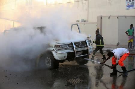 Fire fighters attempt to extinguish a burning car after an explosion in Mogadishu, Somalia September 22, 2018. REUTERS/Feisal Omar