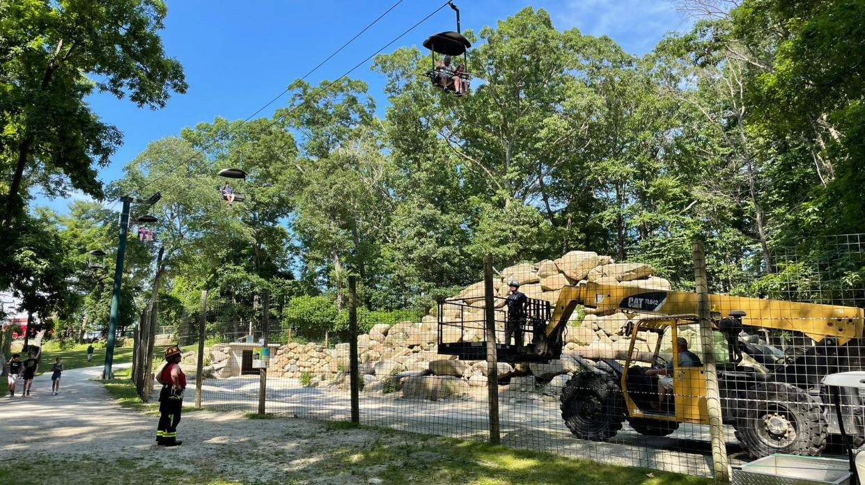 Southwick's Zoo and fire crews work to rescue people trapped on a sky ride at the Mendon zoo Friday.