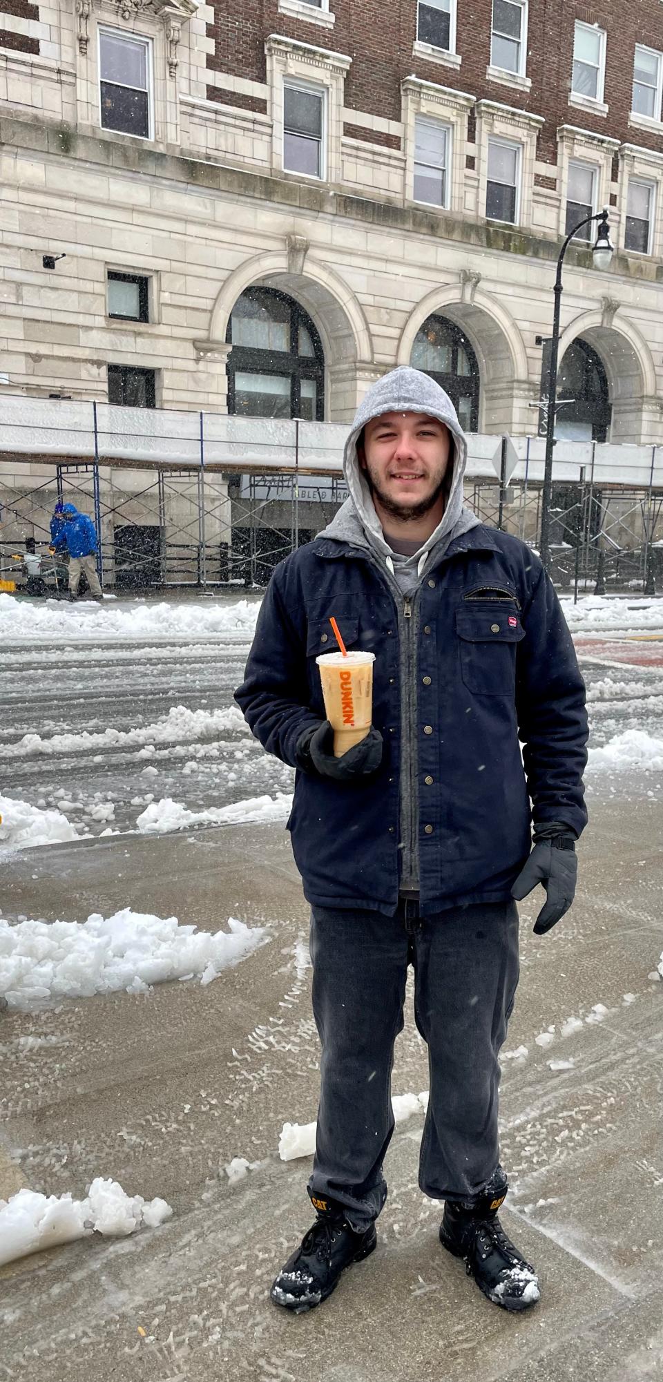 Rich Carter with his daily iced coffee he buys every morning, regardless of weather conditions.