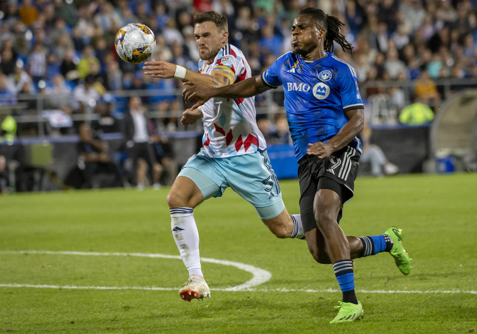 Chicago Fire's Rafael Czichos (5) and CF Montreal's Chinonso Offor (9) race for the ball during the second half of an MLS soccer match in Montreal, Saturday, Sept. 16, 2023. (Peter McCabe/The Canadian Press via AP)