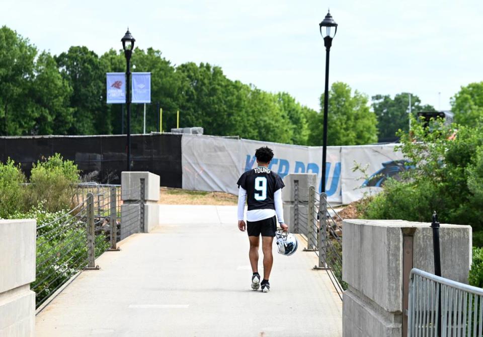 Carolina Panthers quarterback Bryce Young walks to the team’s voluntary minicamp practice in April.