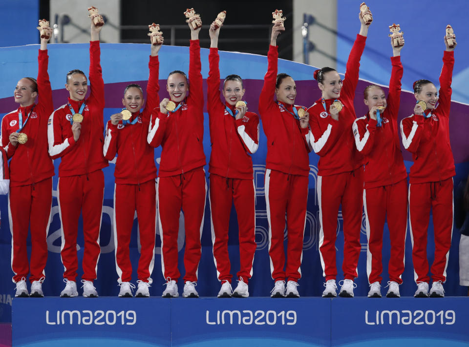 Canada's artistic swimming team celebrates after receiving their gold medals in the finals of team competition free artistic swimming at the Pan American Games in Lima, Peru, Wednesday, July 31, 2019. (AP Photo/Moises Castillo)