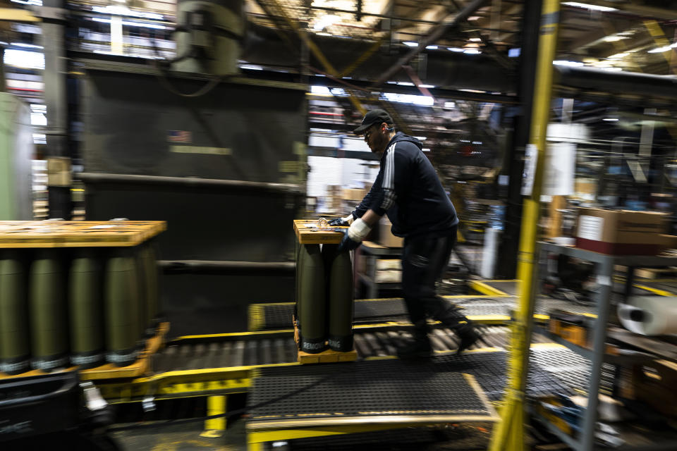 A steel worker moves 155 mm M795 artillery projectiles at the Scranton Army Ammunition Plant in Scranton, Pa., Thursday, April 13, 2023. One of the most important munitions of the Ukraine war comes from a historic factory in this city built by coal barons, where tons of steel rods are brought in by train to be forged into the artillery shells Kyiv can’t get enough of — and that the U.S. can’t produce fast enough. (AP Photo/Matt Rourke)