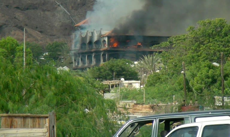 Flames and smoke rise from Sheikh bin Farid palace, used as a base by the Saudi-led coalition forces, after it was hit by a rocket attack on October 6, 2015 on the outskirts of Aden