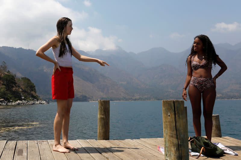 Backpacker and Spanish language student Daehler talks with her friend following the outbreak of coronavirus disease (COVID-19) in San Pedro La Laguna