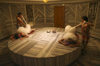 German couple Renate Malzahn and her husband, Harry Malzahn enjoy a Turkish bath in Antalya, southern Turkey, Saturday, June 19, 2021. Hotels in Turkey's Antalya region, a destination beloved by holidaymakers, are preparing to finally resume operations as they expect the return of international tourists after months of setbacks caused by the pandemic that halted travel. (AP Photo/Emrah Gurel)