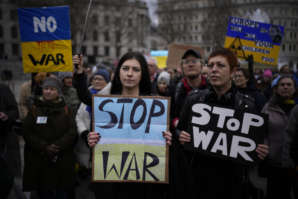 People hold placards as they take part in a protest against the Russian invasion of Ukraine, in Trafalgar Square, London, Saturday, March 5, 2022. What looked like a breakthrough cease-fire to evacuate residents from two cities in Ukraine quickly fell apart Saturday as Ukrainian officials said shelling had halted the work to remove civilians hours after Russia announced the deal. (AP Photo/Matt Dunham)