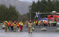 Passengers rescued from the Viking Sky cruise ship are helped from a helicopter in Hustadvika, Norway, Saturday March 23, 2019. A cruise ship with engine problems sent a mayday call off Norway's western coast on Saturday, then began evacuating its 1,300 passengers and crew amid stormy seas and heavy winds in a high-risk helicopter rescue operation. (Odd Roar Lange/NTB Scanpix via AP)