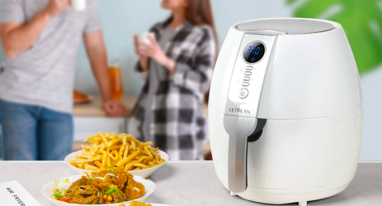 white Ultrean Air Fryer with plate of french fries and onion rings on kitchen counter