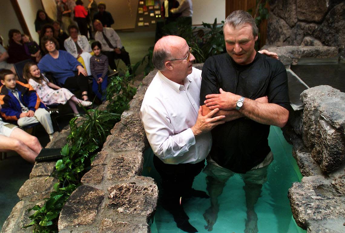 Pastor Dale White, senior pastor at the Cathedral of Joy, prays over Curt Morgan of Benton City during a Baptism celebration in March 1999 at the Richland church.