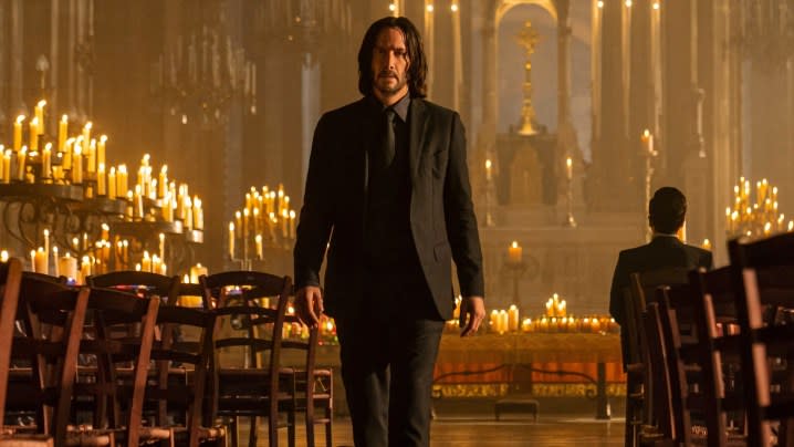 Keanu Reeves as John Wick stands in a church in "John Wick: Chapter 4."