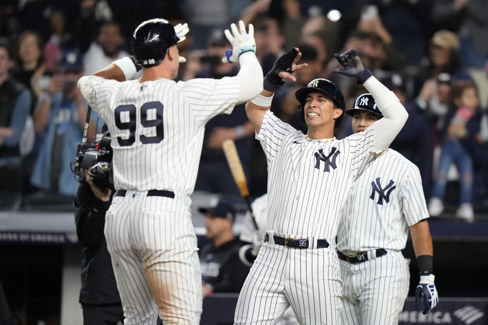 New York Yankees' Oswaldo Cabrera, center, and Oswald Peraza, right, celebrate with Aaron Judge after they scored on a three-run home run by Judge against the Arizona Diamondbacks during the third inning of a baseball game Friday, Sept. 22, 2023, in New York. (AP Photo/Frank Franklin II)