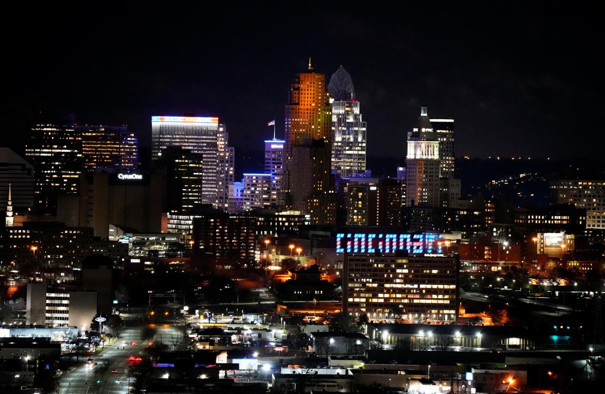 The Cincinnati sign on the Duke Energy Convention Center is illuminated in blue on Jan. 3, 2023, seen from Olden View Park in East Price Hill, in support of Buffalo Bills safety Damar Hamlin who collapsed during a Cincinnati Bengals game. Hamlin has since recovered.