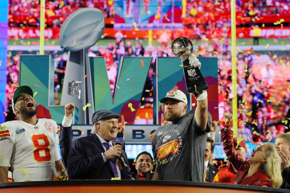 Travis Kelce hoists the Vince Lombardi Trophy after Super Bowl LVII.