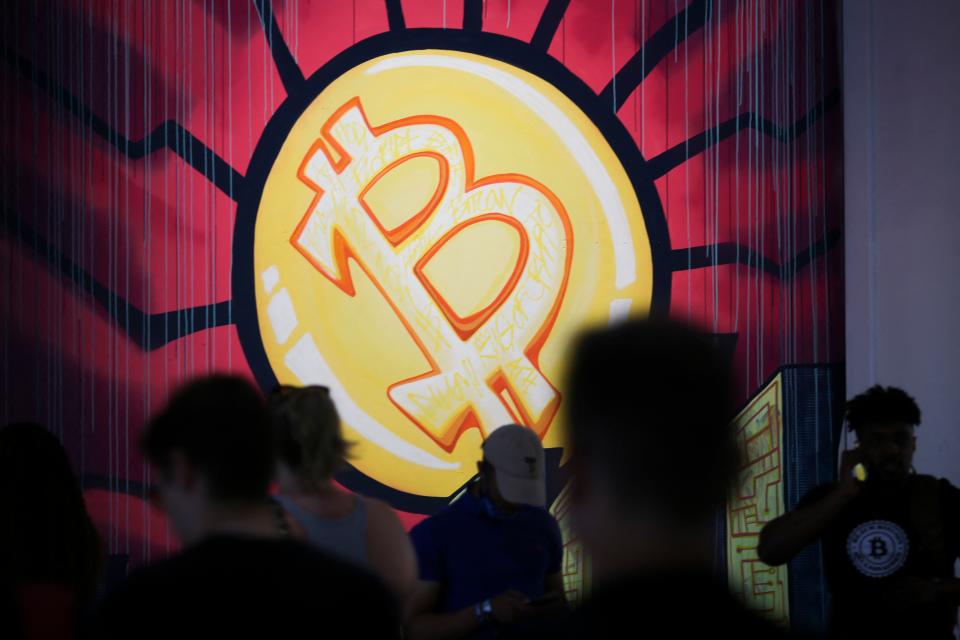 A banner (designed by artists Stacey Coon, Anastasia Sultzer, and Nanu Berks) with the logo of bitcoin is seen during the crypto-currency conference Bitcoin 2021 Convention at the Mana Convention Center in Miami, Florida, on June 4, 2021. (Photo by Marco BELLO / AFP) / The mention[s] appearing in the metadata of this photo by Marco BELLO has been modified in AFP systems adding the credit of the artists who designed the banner in the background : Stacey Coon, Anastasia Sultzer, and Nanu Berk. Please immediately remove previous versions from all your online services and delete it (them) from your servers. If you have been authorized by AFP to distribute it (them) to third parties, please ensure that the same actions are carried out by them. Failure to promptly comply with these instructions will entail liability on your part for any continued or post notification usage. Therefore we thank you very much for all your attention and prompt action. We are sorry for the inconvenience this notification may cause and remain at your disposal for any further information you may require. (Photo by MARCO BELLO/AFP via Getty Images)