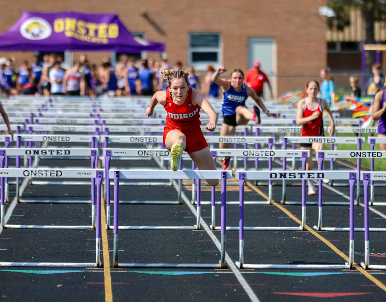 Addison's Molly Brown runs the high hurdles during the Onsted Boosters Invite.