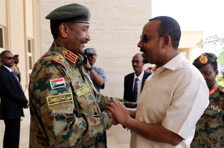 FILE PHOTO: Ethiopian Prime Minister Abiy Ahmed meets Sudan's Head Of Transitional Military Council, Lieutenant General Abdel Fattah Al-Burhan Abdelrahman to mediate in the political crisis at the airport in Khartoum