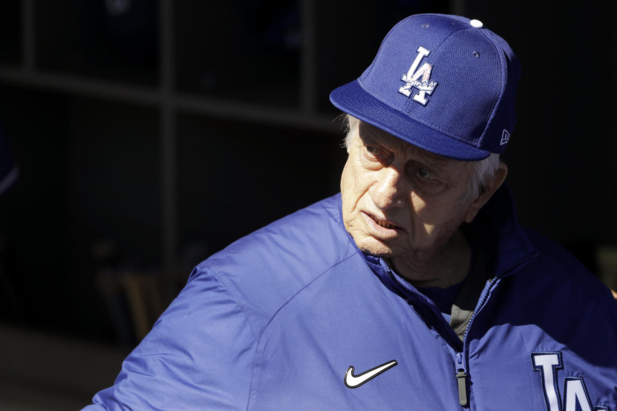 Former Los Angeles Dodgers manager Tommy Lasorda looks on from the dugout before a spring training baseball game against the Los Angeles Angels, Wednesday, Feb. 26, 2020, in Glendale, Ariz. (AP Photo/Gregory Bull)