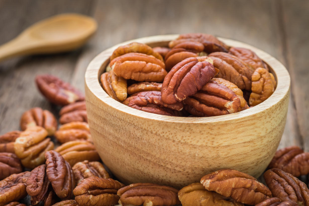 Pecan nuts in wooden bowl