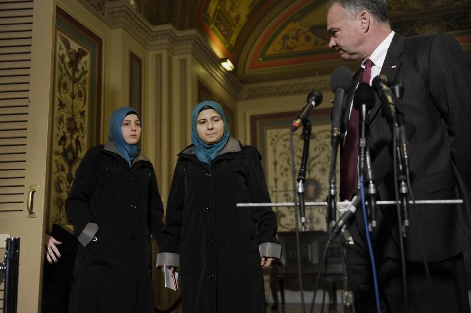 Sen. Tim Kaine, D-Va, chairman of the Senate Foreign Relations subcommittee on Near Eastern, Southern and Central Asian Affairs, right, is joined at a news conference on Capitol Hill in Washington, Thursday, Feb. 6, 2014, by Heba Sawan, center, and her sister Amineh Sawan, left. The Sawan sisters were survivors of the August 2013 chemical weapons attack in Moadamiya, Syria that left more than 1,200 Syrians dead and many more wounded. (AP Photo/Susan Walsh)