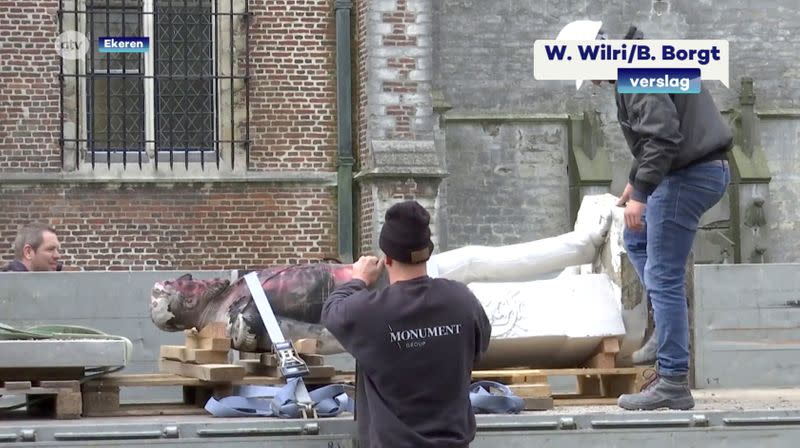 A damaged statue of former Belgian King Leopold II is seen being removed for possible renovation in Ekeren