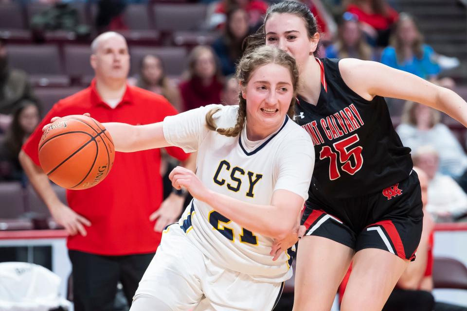 Christian School of York's Linda Brown gets around Mount Calvary Christian's Rachel Thomas during the first quarter of the District 3 Class 1A girls' basketball championship at the Giant Center on Saturday, March 5, 2022, in Derry Township. The Defenders fell, 27-26.